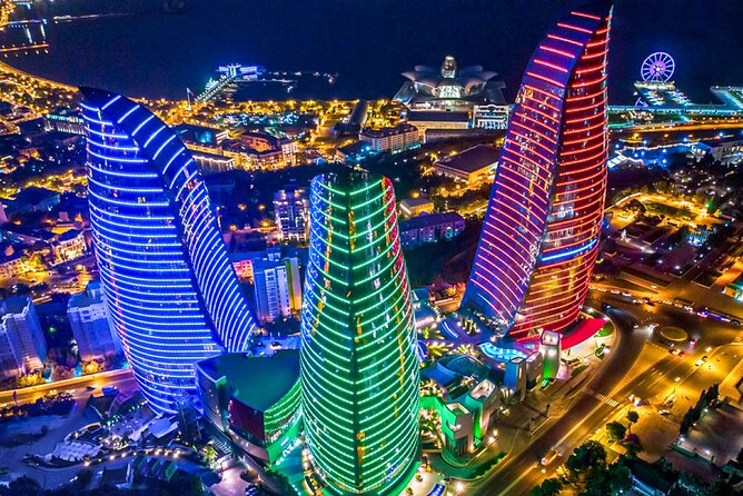 Baku Night City Tour Discover the Magic of Illuminated Landmarks - Baku after dark, from towers to sea views