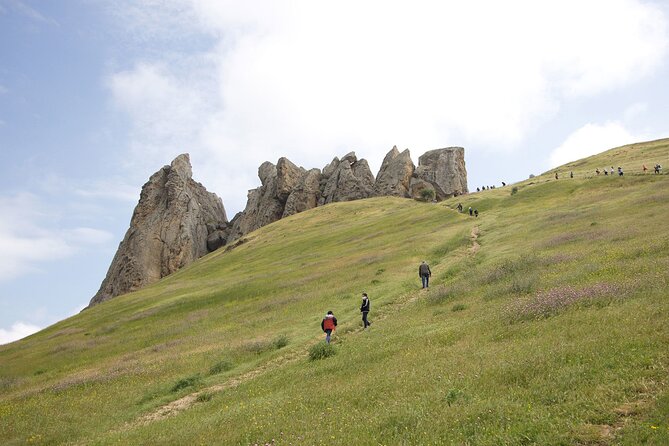 Beshbarmag mountain with sea view and Candy Mountains <em> Day Tour – Key points at a glance’ /></p>
<ul>
<li><strong>Beshbarmag’s Caspian setting:</strong> See where the Greater Caucasus comes close to the sea, at a site tied to centuries of prayer and travel.</li>
<li><strong>Three very different natural stops:</strong> Masazir offers unusual color, Candy Cane Mountain offers striped earth, and Beshbarmag offers rock, views, and local belief.</li>
<li><strong>A small maximum group of 12:</strong> This makes questions and guide commentary easier than on a large coach trip.</li>
<li><strong>Strong guide names to look for:</strong> Samir, Sabina, and Riad have been singled out for friendly, clear, and entertaining guiding.</li>
<li><strong>A useful Baku finale:</strong> The Heydar Mosque and Heydar Aliyev Centre add major city sights after the countryside stops.</li>
<li><strong>Good value at $60:</strong> Transport, a professional guide, tea, and selected hotel pickup are included, but admission to the cultural center is extra.</li>
</ul>
<h2 id="why-this-baku-day-trip-works">Why this Baku day trip works</h2>
<p> Day Tour – Why this Baku day trip works’ /></p>
<p><p>This is not a single-theme outing. It combines odd natural sights, a revered mountain, and two important Baku buildings in roughly eight hours. That variety is the reason I think it works well for a short stay. You get beyond the city without giving up the chance to see two of Baku’s better-known modern landmarks.</p>
</p>
<p><p>The route also gives you a quick sense of Azerbaijan’s contrasts. Masazir is a low, quiet lake near the capital. Candy Cane Mountain looks like an artist has brushed pale red and white bands across the hills. Beshbarmag brings a more serious mood, with its old route, sharp rock formation, and continuing role as a place of prayer.</p>
</p>
<p><p>The experience begins at 9:00 a.m. and uses an air-conditioned vehicle. Pickup is offered from selected hotels, so check your exact pickup point before booking. The group maximum is 12 people, a useful middle ground: more social than a private tour, but far less unwieldy than a big bus.</p>
</p>
<p><p>At $60 per person, I see solid value if you want several sights in one day and do not want to arrange transport yourself. The price includes the vehicle, guide, tea, and selected hotel pickup. Personal spending and alcoholic drinks are extra, and the admission fee for the Heydar Aliyev Centre is not included.</p>
</p>
<div class="twil" style="margin: 20px 0; padding: 15px 0;"><p>More candy cane mountains tours in Baku:</p><ul style="margin: 10px 0; padding-left: 0; list-style: none;"><li style="margin: 0 0 12px 0; padding: 0 0 12px 0; border-bottom: 1px solid #DEEAEF; line-height: 1.4;"><a href="https://azerbaijantourreviews.com/baku-candy-cane-guba-khinaliq-village-with-homemade-lunch/">Baku: Candy Cane, Guba, Khinaliq village with Homemade Lunch</a><br><span style="font-size: 0.82em; color: #555;"><span style="color: #12668A;">★</span> 4.9 &nbsp;&middot;&nbsp; 519 reviews</span></li><li style="margin: 0 0 12px 0; padding: 0 0 12px 0; border-bottom: 1px solid #DEEAEF; line-height: 1.4;"><a href="https://azerbaijantourreviews.com/baku-guba-khinalig-candy-cane-tour-with-homemade-lunch/">Baku: Guba Khinalig & Candy Cane Tour with Homemade Lunch</a><br><span style="font-size: 0.82em; color: #555;"><span style="color: #12668A;">★</span> 4.9 &nbsp;&middot;&nbsp; 447 reviews</span></li><li style="margin: 0; padding: 0; border-bottom: none; line-height: 1.4;"><a href="https://azerbaijantourreviews.com/baku-candy-mountain-pink-lake-besh-barmag-dag-and-mosque/">Baku: Candy Mountain, Pink Lake, Besh Barmag Dag and Mosque</a><br><span style="font-size: 0.82em; color: #555;"><span style="color: #12668A;">★</span> 4.6 &nbsp;&middot;&nbsp; 273 reviews</span></li></ul></div><h2 id="masazir-lake-and-the-problem-of-distance">Masazir Lake and the problem of distance</h2>
<p><img width="669" height="446" decoding="async" src=