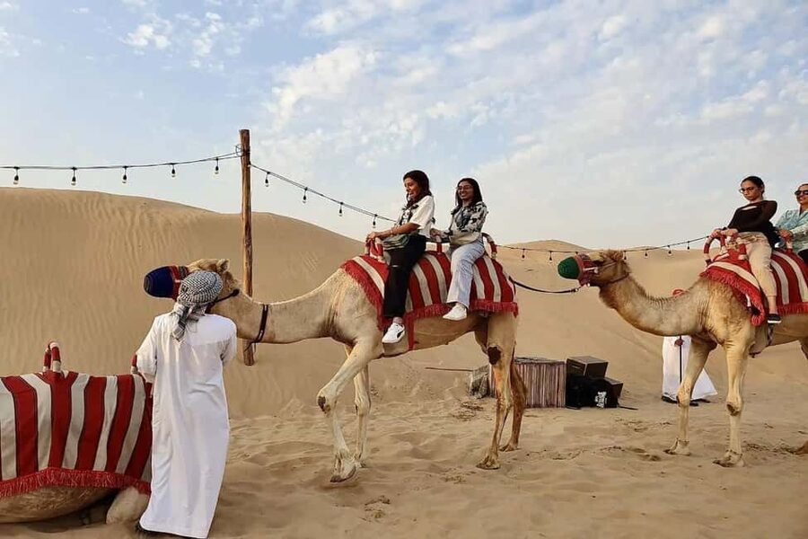 Dubai: Desert Safari, Camel Ride, Quad Bike & BBQ Dinner - Camel riding and sandboarding in the open desert